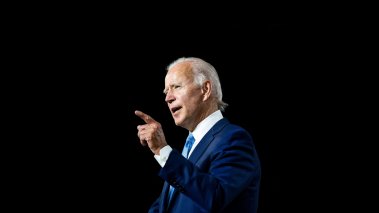 President Joe Biden speaking against a black background