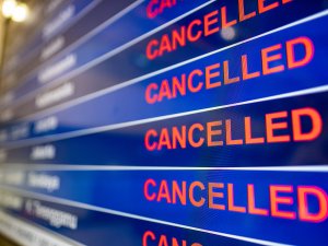 Airport screen indicating cancelled flights