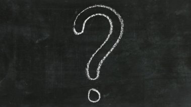 large question mark in chalk on a blackboard