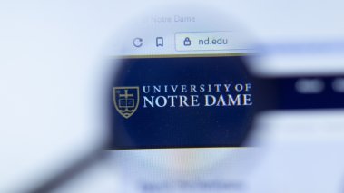 University of Notre Dame website logo under magnifying glass