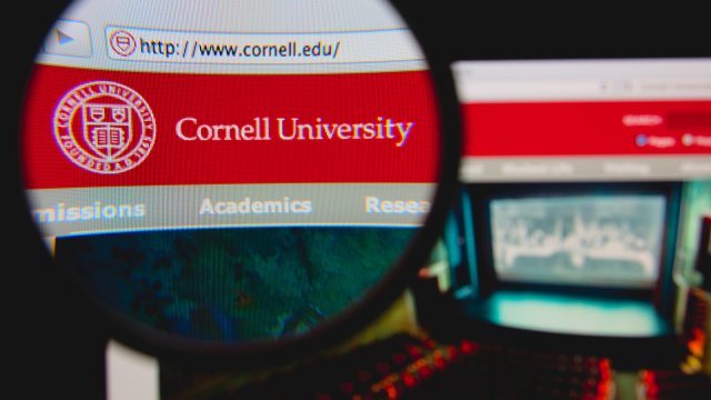Cornell University homepage on a monitor screen through a magnifying glass