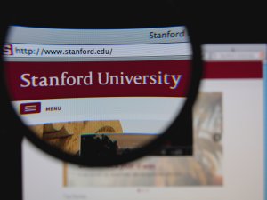 Photo of Stanford University homepage on a monitor screen through a magnifying glass 