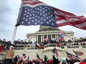 An upside down American flag waves as pro-Trump protestors took over the steps of the Capital in Washington, DC, Wednesday, January 6, 2021 Capitol Takeover