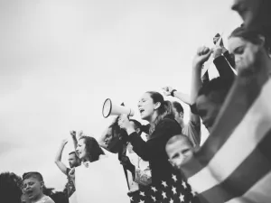 Woman with bullhorn in a crowd
