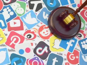 Wooden gavel on logos of popular social networks