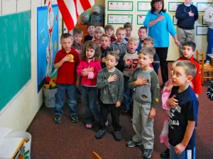 students stand to recite pledge of allegiance