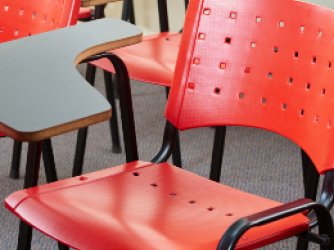 red classroom chairs with attached desks. 