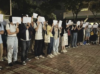 Protesters hold up blank white papers in China
