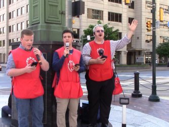Evangelist Rodney Keister stands with two other men in Harrisburg preaching on the street