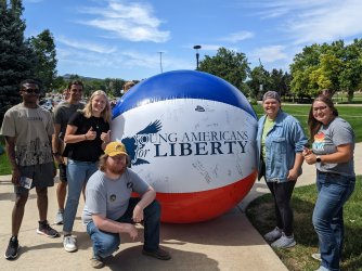 Members of Young Americans for Liberty at Black Hills State University standing in front of a giant beach ball