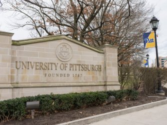 University of Pittsburgh entrance sign with banner 