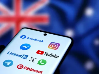 Smart phone showing social media icons with the flag of Australia in the background