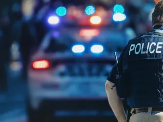 Police officer in front of a squad car