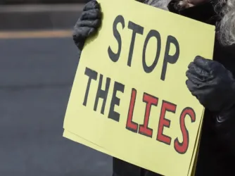 Jan. 11, 2026 – Protester holding a sign at the Ice Out for Good protest in Rockville, MD