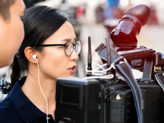 Student journalist filming on campus