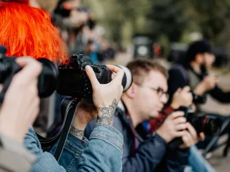 Student journalist taking a photograph