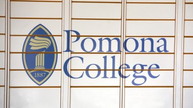 A sign with Pomona College's logo on campus.
