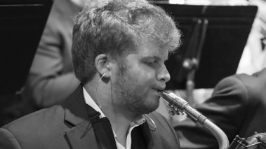Tim Hecker black and white playing saxophone