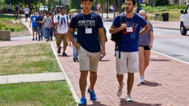 Penn State students walking outdoors at an orientation