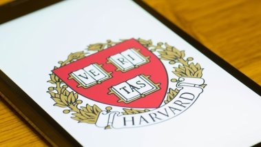 A Smartphone screen shows logo of Harvard University.