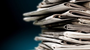 Pile of newspapers on blue background