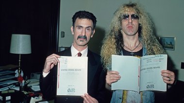 American musicians Dee Snider and Frank Zappa hold up papers relating to the PMRC senate hearing at Capitol Hill, Washington DC, United States, 19th September 1985.