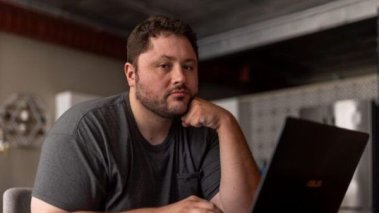 Anthony Novak sits at his computer