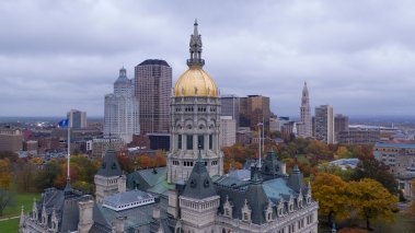 Downtown buildings under a dark sky at the Connecticut state capitol building in Hartford 
