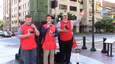 Evangelist Rodney Keister stands with two other men in Harrisburg preaching on the street