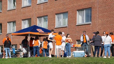 Syracuse University community members gather on campus