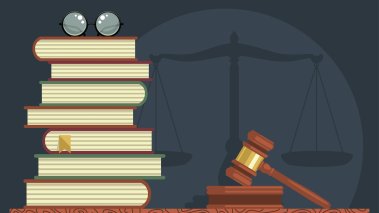 Stack of books with glasses and judge gavel 