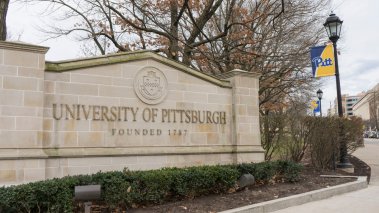 University of Pittsburgh entrance sign with banner 
