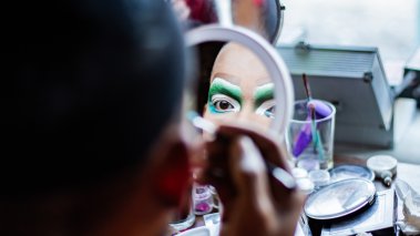 Drag performer putting on makeup