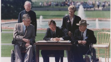 President George H.W. Bush signs the Americans with Disabilities Acton the South Lawn of the White House