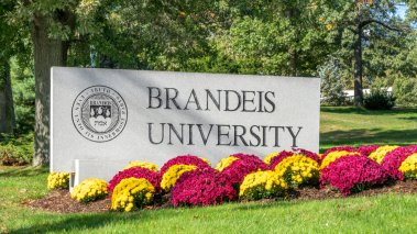 Brandeis University entrance sign and campus logo 