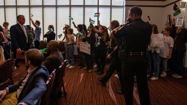 Florida State University students attend an FSU Board of Trustees meeting where they waived Palestinian flags and chanted before being escorted out by the police