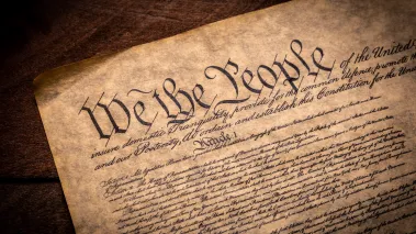 Copy of the Constitution of the United Sates of American on a wooden background
