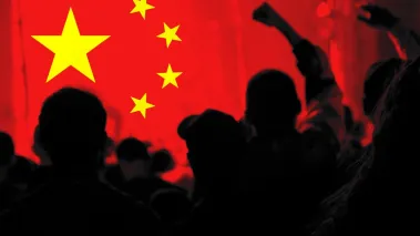 Silhouette of protesters against Chinese flag