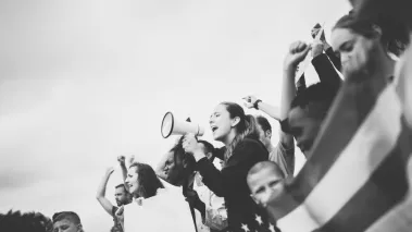 Woman with bullhorn in a crowd
