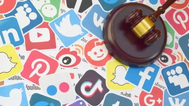 Wooden gavel on logos of popular social networks