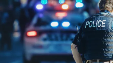 Police officer in front of a squad car