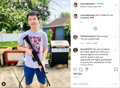 Fordham student Austin Tong posing with a rifle.