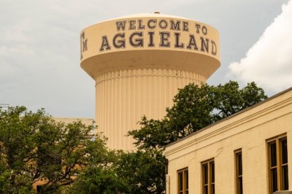 A water tower with "Welcome to Aggieland" written on it.