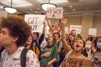 Student protestors wave signs