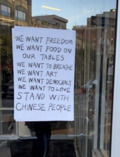 signs read  “We Want Freedom” and “We Want Democracy stand with Chinese People"