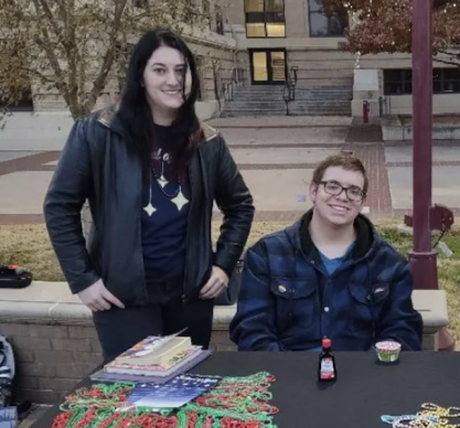 FIRE plaintiffs Laur Stovall and Bear Bright at a table on campus.