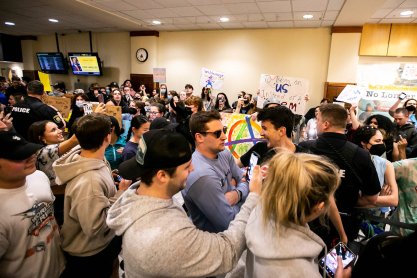 Transgender-rights protesters chant as people wait in line to hear Matt Walsh speak at an event hosted by the Young America's Foundation at the University of Iowa