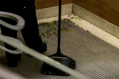 University of Iowa Police works to clean up marbles spilled by a protester in a staircase as Matt Walsh event