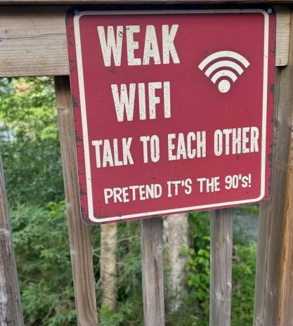 Sign reading "Weak Wifi. Talk to Each other. Pretend it's the 90's!