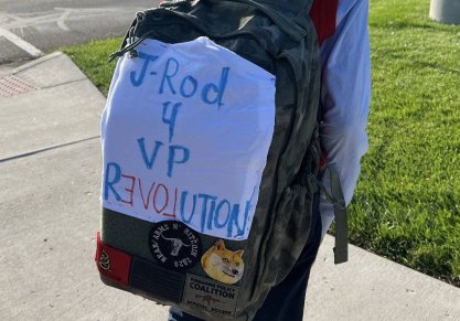 Child wearing a backpack featuring the Gadsen Flag and words, "J-Rod 4 VP Revolution"